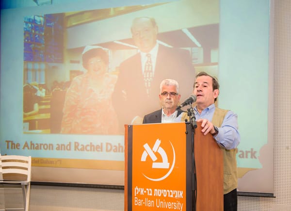 Nick Dahan (left) with Rabbi Mitchell Wohlberg (speaking)