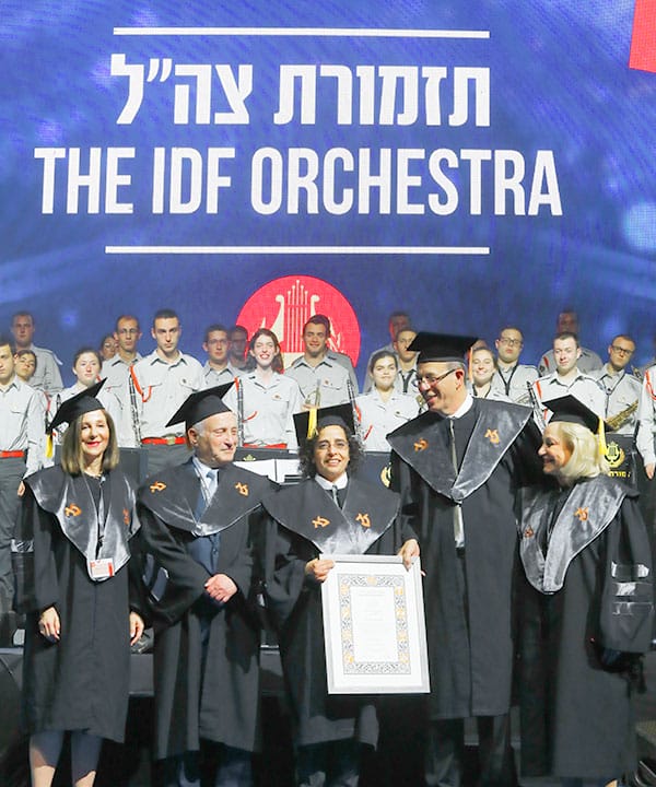 The Israel Defense Forces Orchestra stands at attention as Col. Merav Kirshner (center), head of the IDF Manpower Directorate, accepts the Honorary Doctorate on the IDF Orchestra's behalf. Pictured (l. to r.) are BOT members Dr. Deborah Strassburger and Moshe Podhorzer, President Zaban, and FIDF Chairman Emeritus and BIU 2017 Honorary Doctor Nili Falic