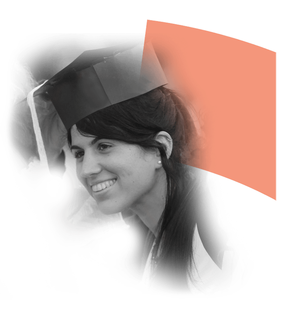 Smiling graduate wearing a cap and gown, celebrating her achievement at a graduation ceremony.