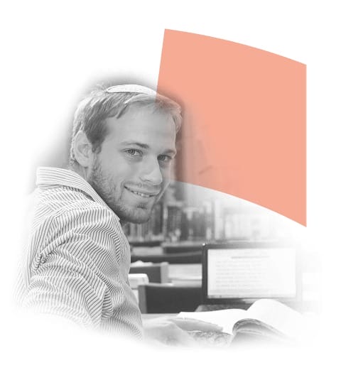 Smiling man with short hair and a kippah sitting at a desk with books, looking at the camera in a library setting. A soft orange shape is overlayed in the background, enhancing the academic atmosphere.