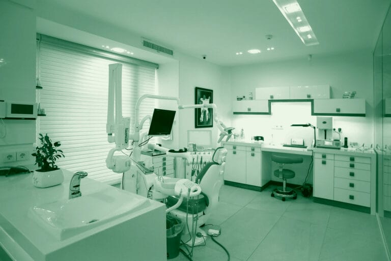 A dentist's office with modern equipment and a clean, minimalist design.